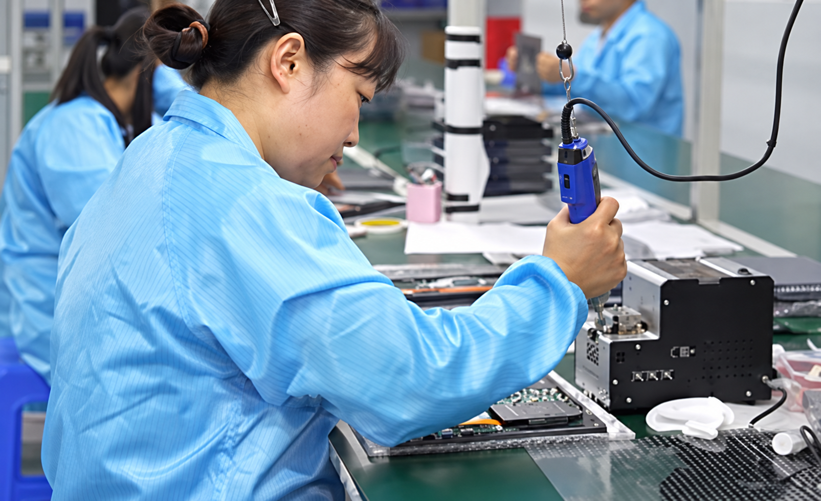 Laptop assembly technician working on a production line
